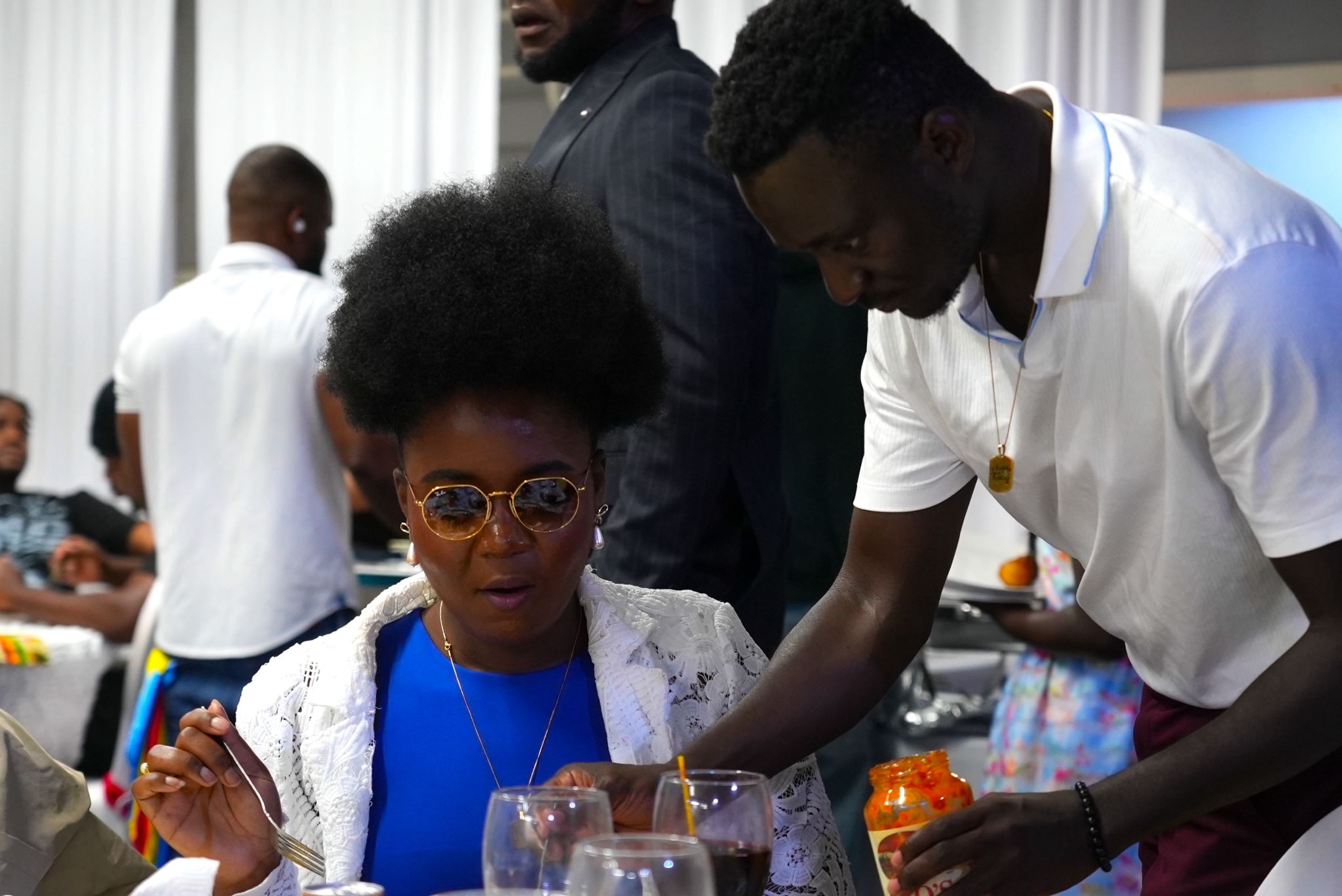 Congolese community members at Independence Day celebration with blue backdrop
